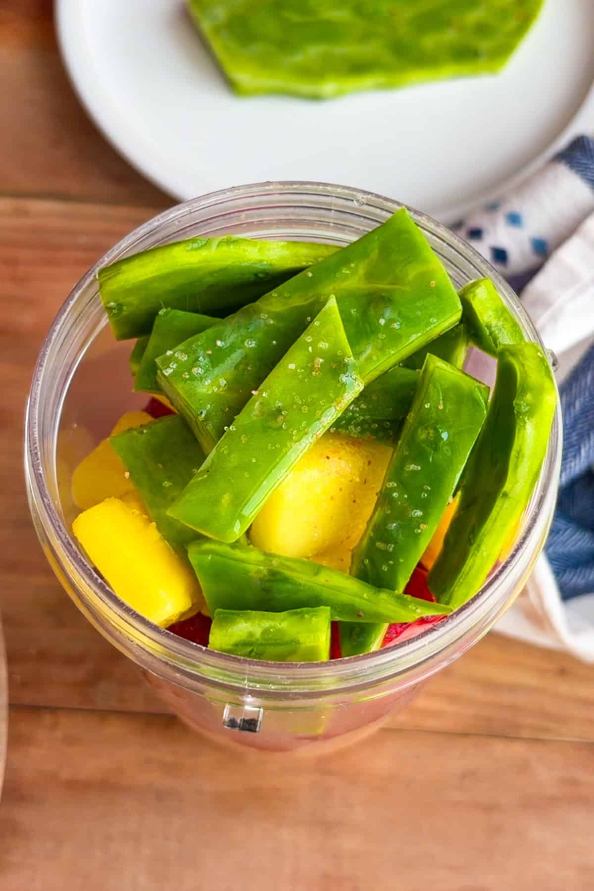 Ingredients for cactus smoothie recipe (licuado de nopales) in a blender.