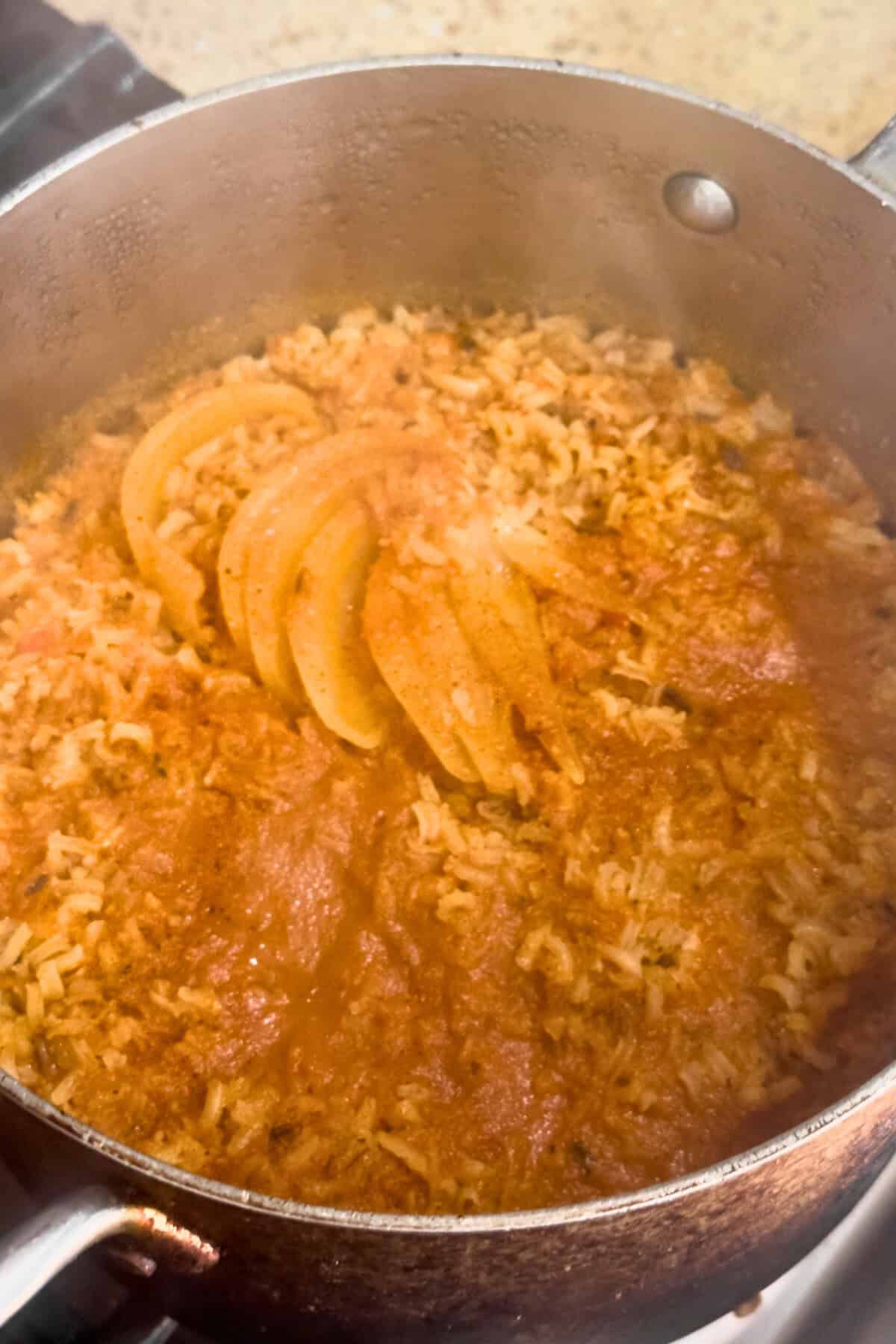 Vegan Mexican rice (arroz rojo) in a pan after being cooked.
