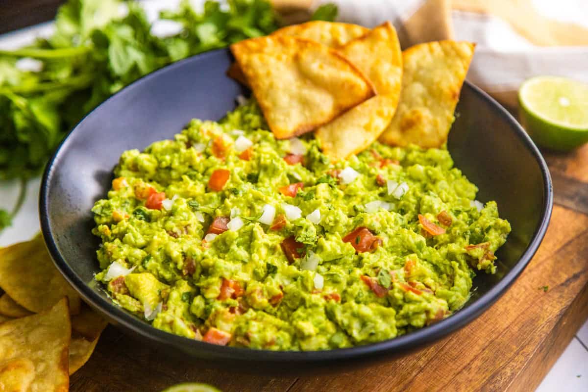 Easy guacamole in a bowl with chips.
