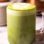 Creamy matcha latte in a clear mug.
