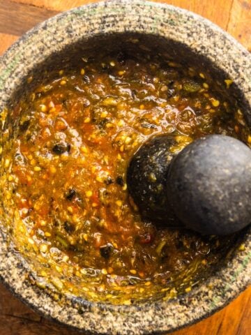 Molcajete salsa in a large molcajete.