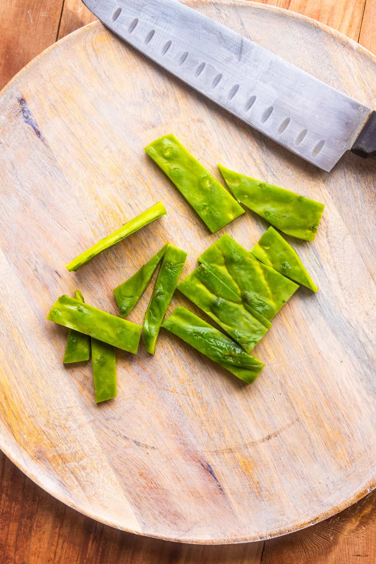 Sliced and prepared nopales on a cutting board.