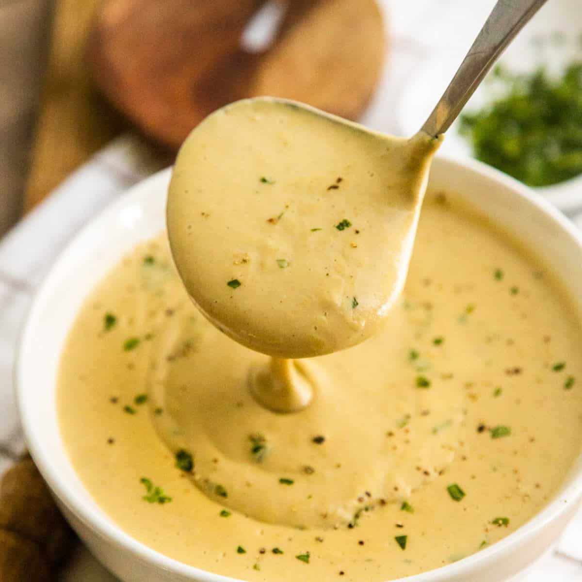 Creamy cashew gravy in a white bowl.