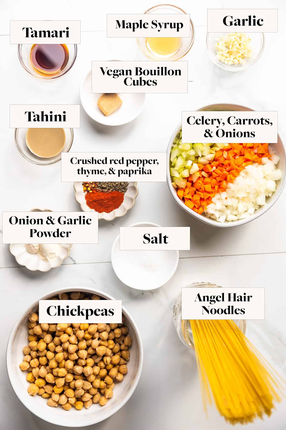 Labeled ingredients for chickpea noodle soup in bowls.