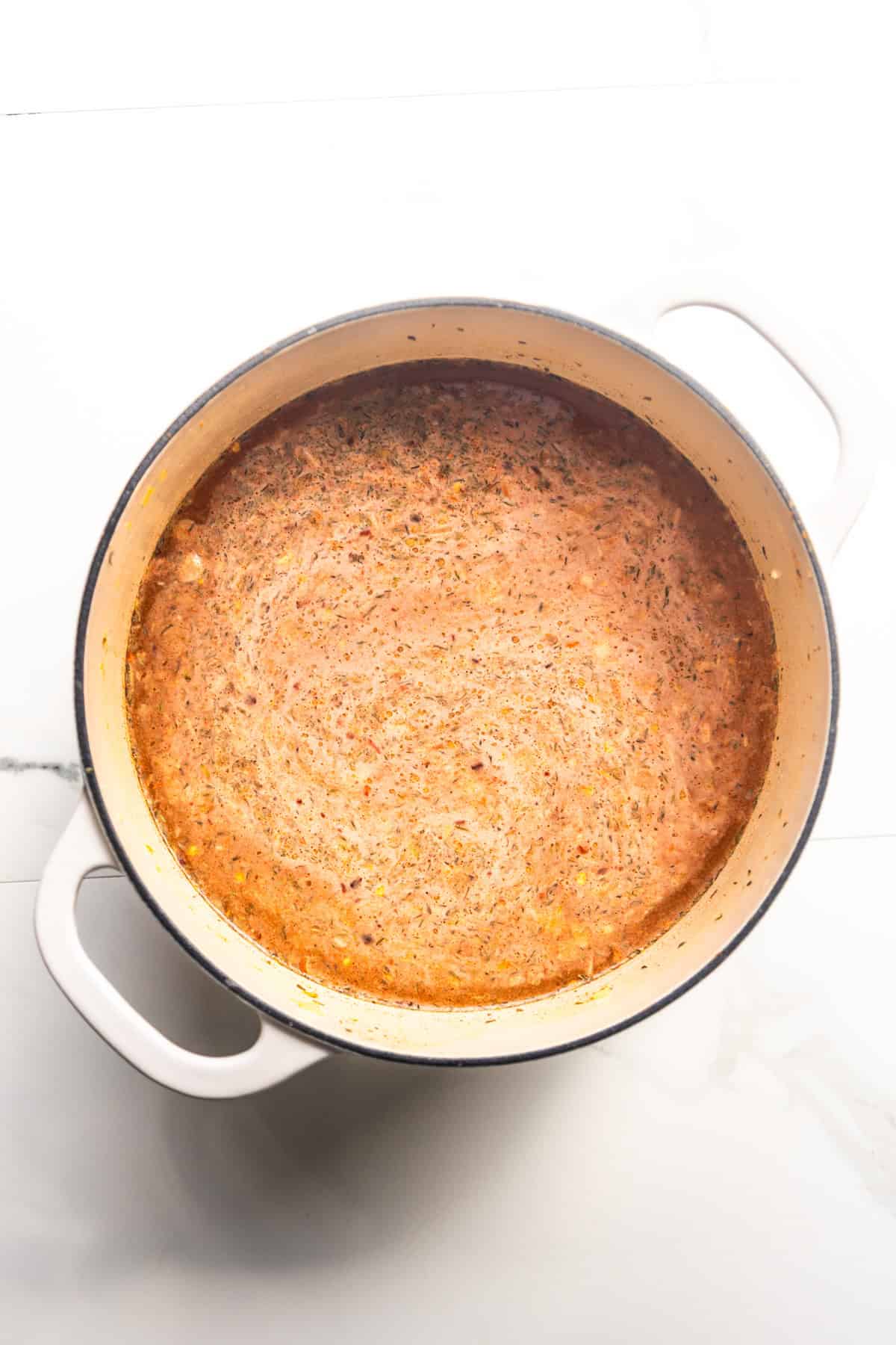 Broth base for vegan chickpea noodle soup in a pot.