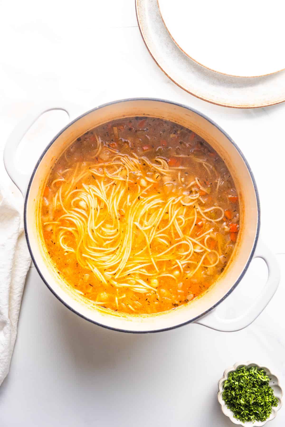 Finished vegan chickpea noodle soup in a pot.