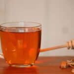 Cuachalalate tea with a honey stick on the side.