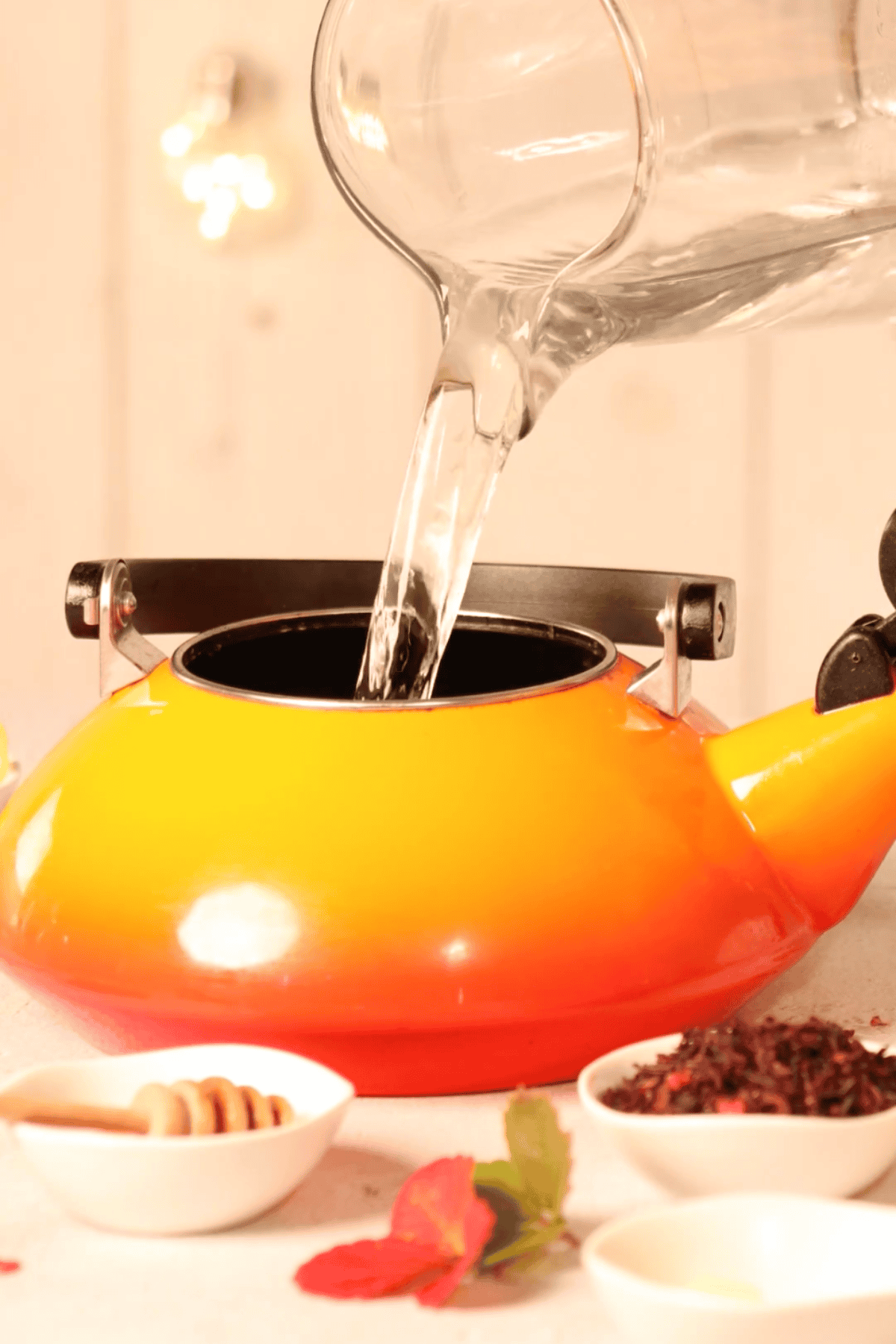 Water pouring into a tea kettle.