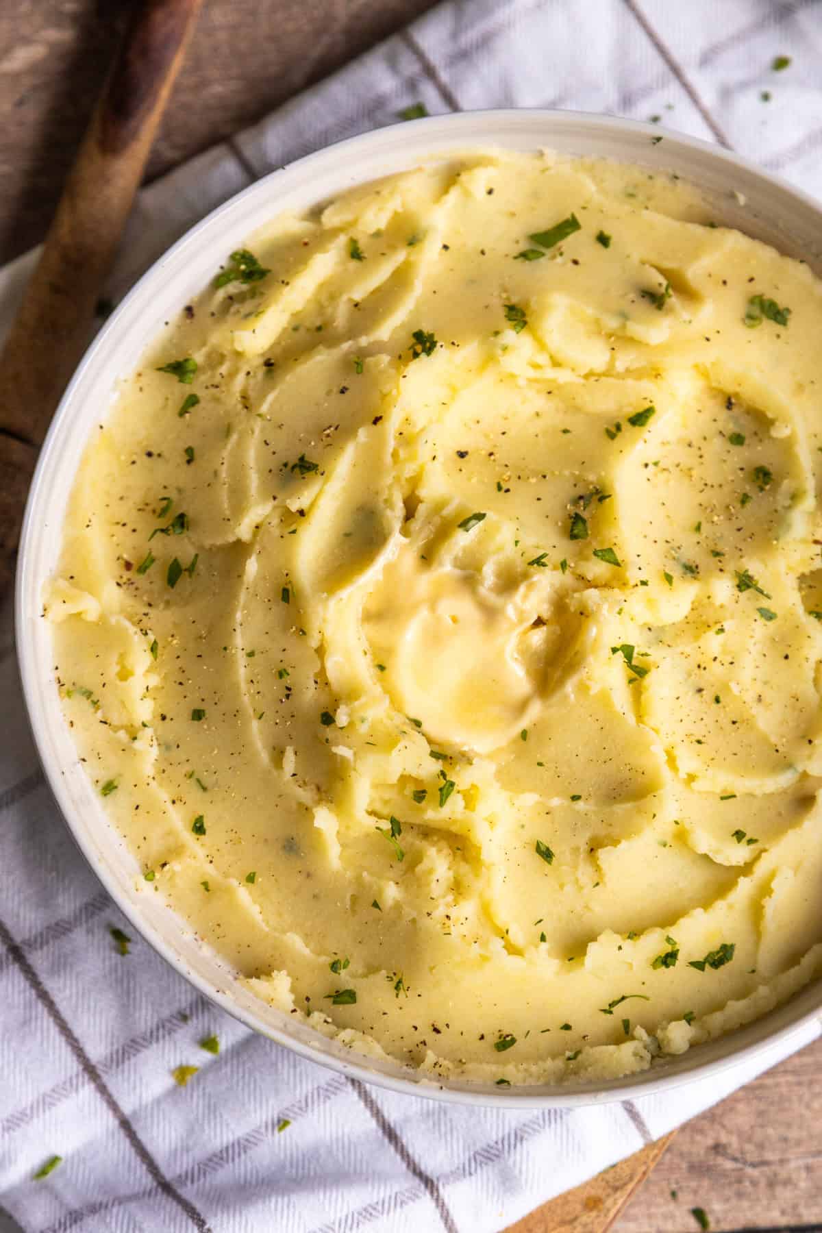 Creamy vegan mashed potatoes in a white bowl.