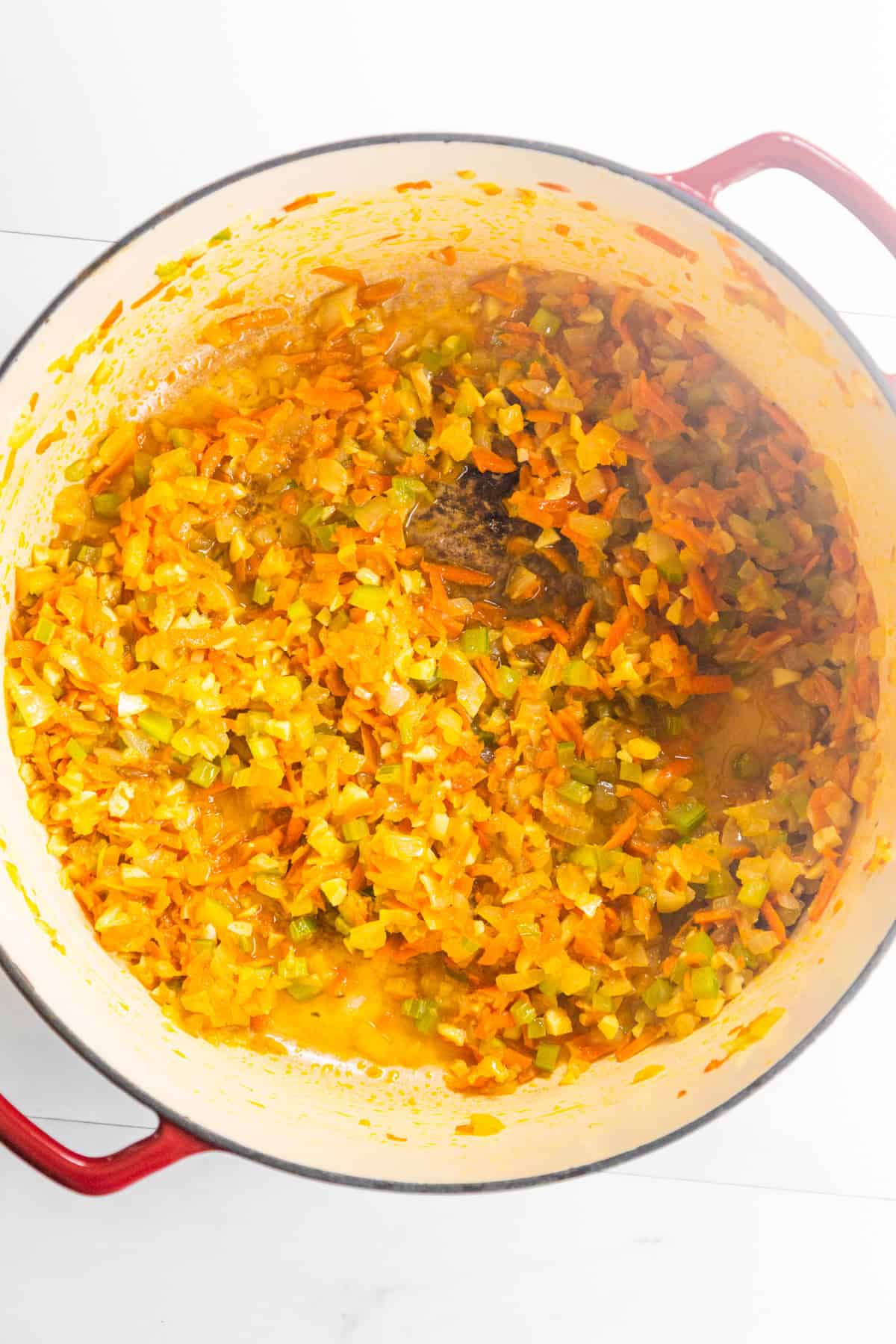 Vegetables sautéing in a dutch oven.