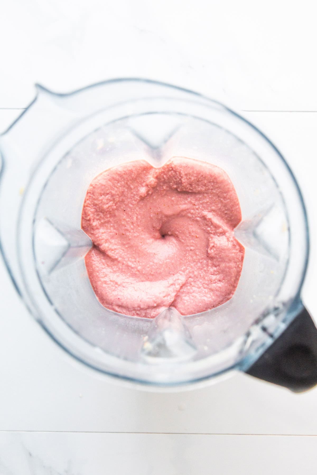 Strawberry banana smoothie without yogurt blended in a blender.