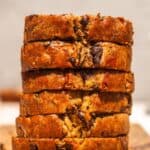 Vegan chocolat chip banana nut bread cut into slices and stacked.