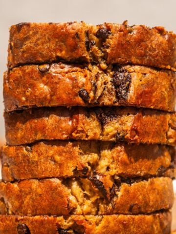 Vegan chocolat chip banana nut bread cut into slices and stacked.