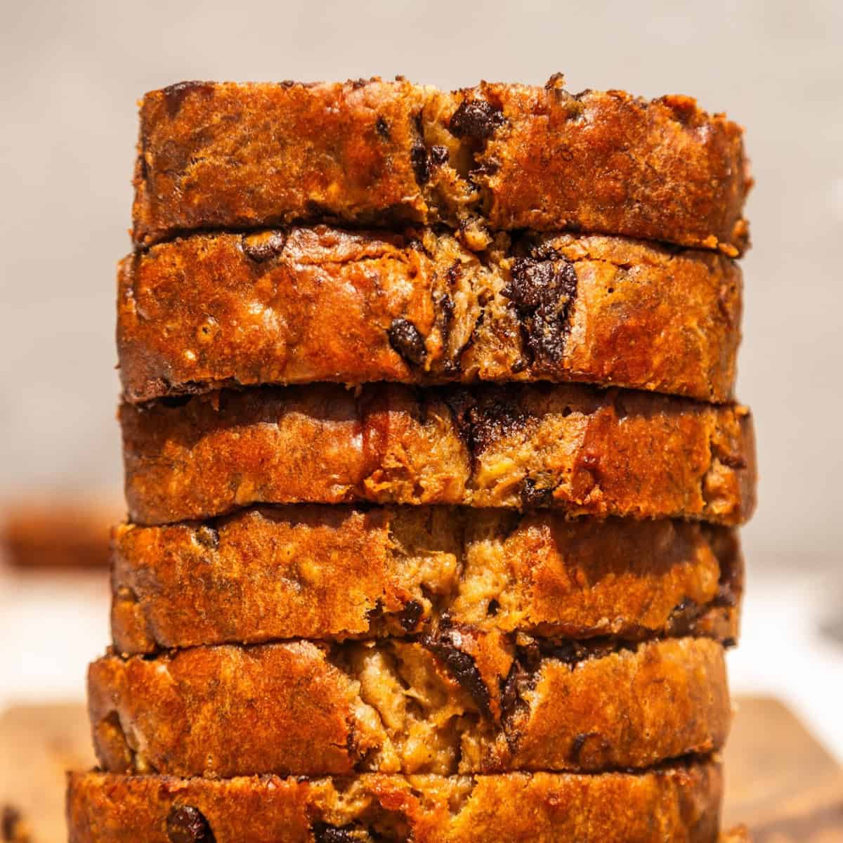 Vegan chocolat chip banana nut bread cut into slices and stacked.