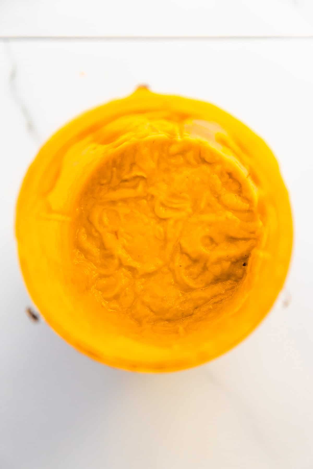 Creamy avocado tomato salsa in a blender after blending.