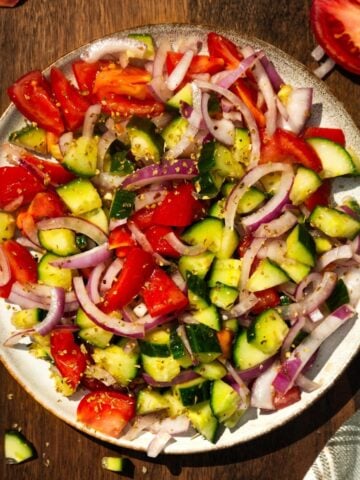 Cucumber tomato salad on a plate.