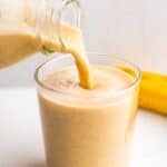Korean banana milk pouring into a glass.