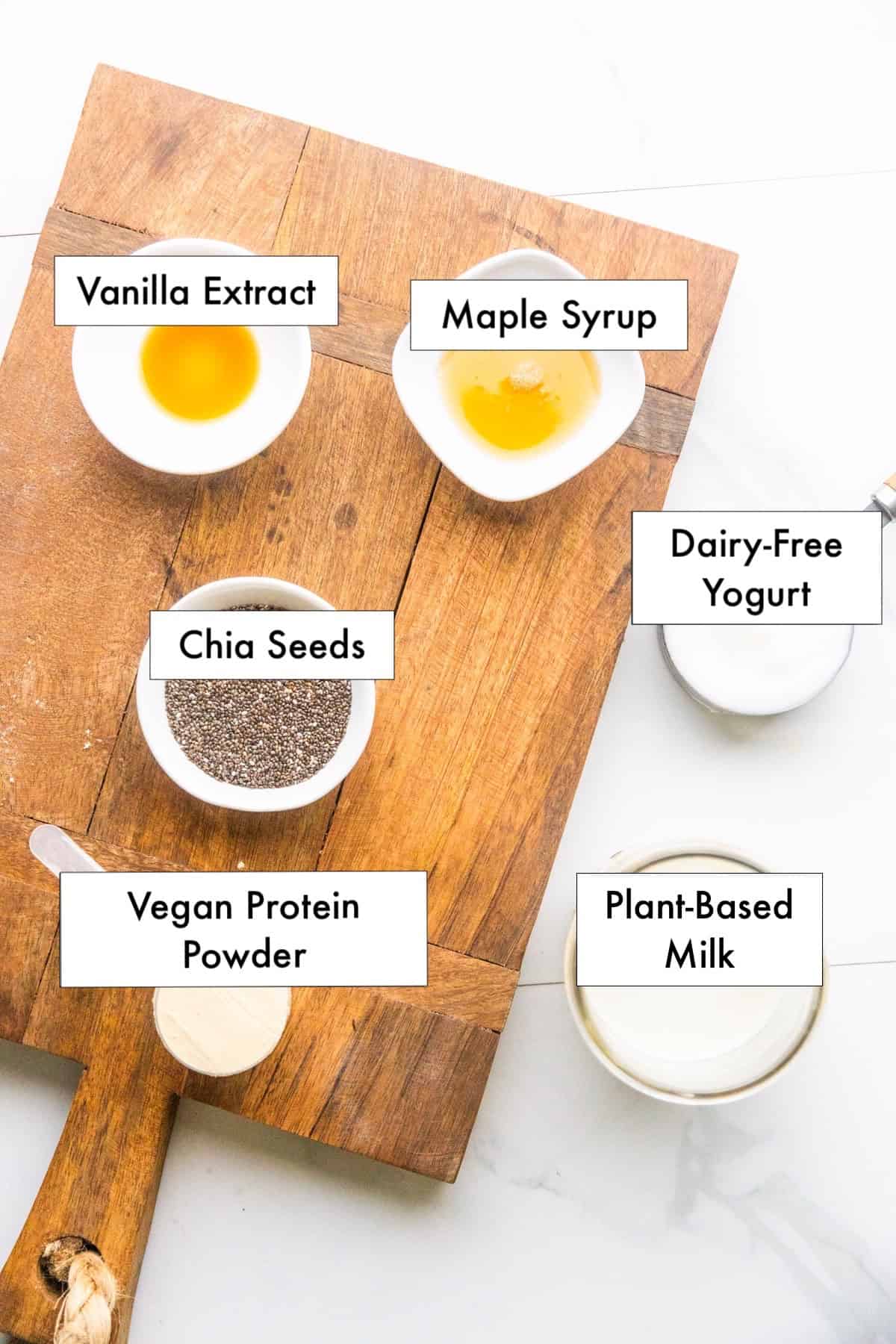 Ingredients for vegan protein chia pudding in labeled bowls.