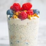 Vegan protein chia pudding in a mason jar topped with berries.