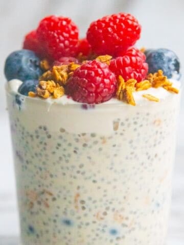 Vegan protein chia pudding in a mason jar topped with berries.