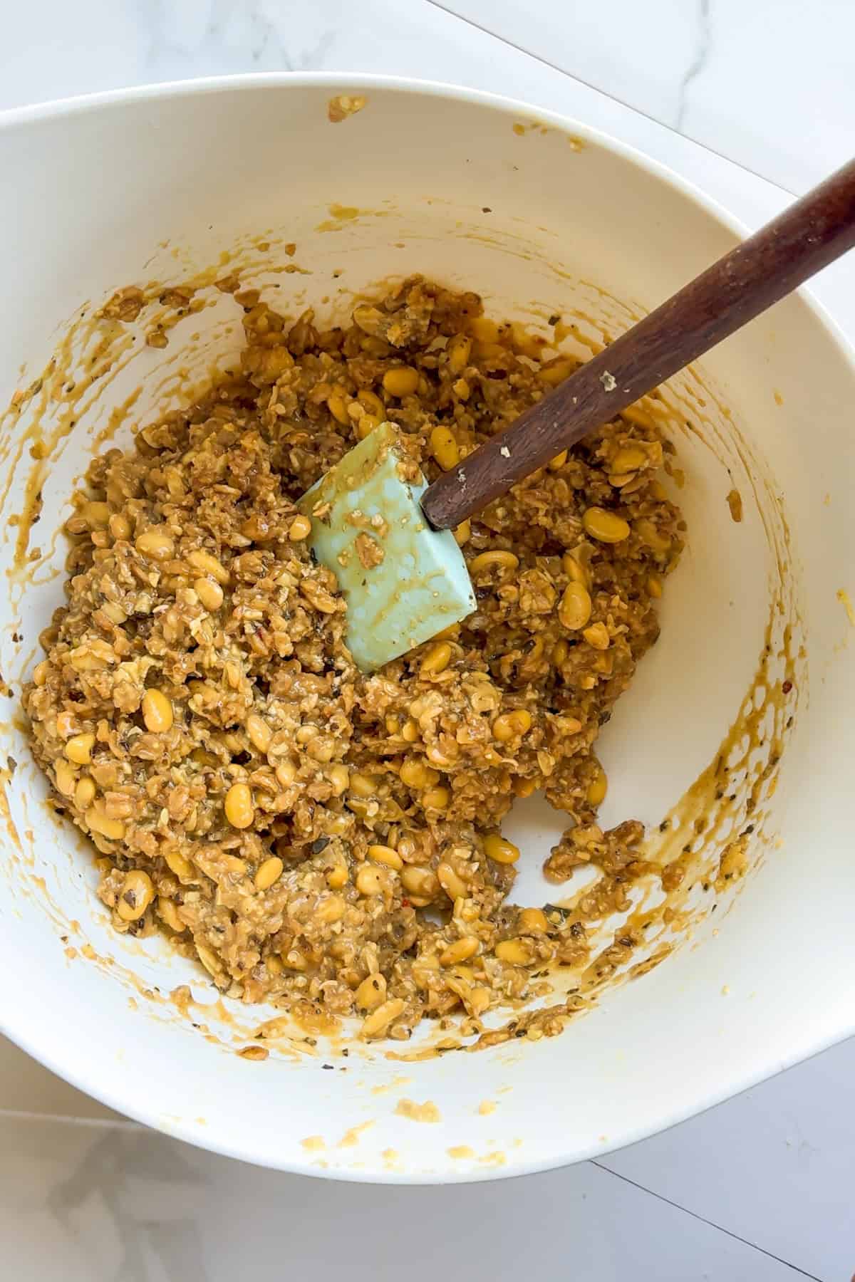 Raw soy burger patty mixture mixing in a bowl.