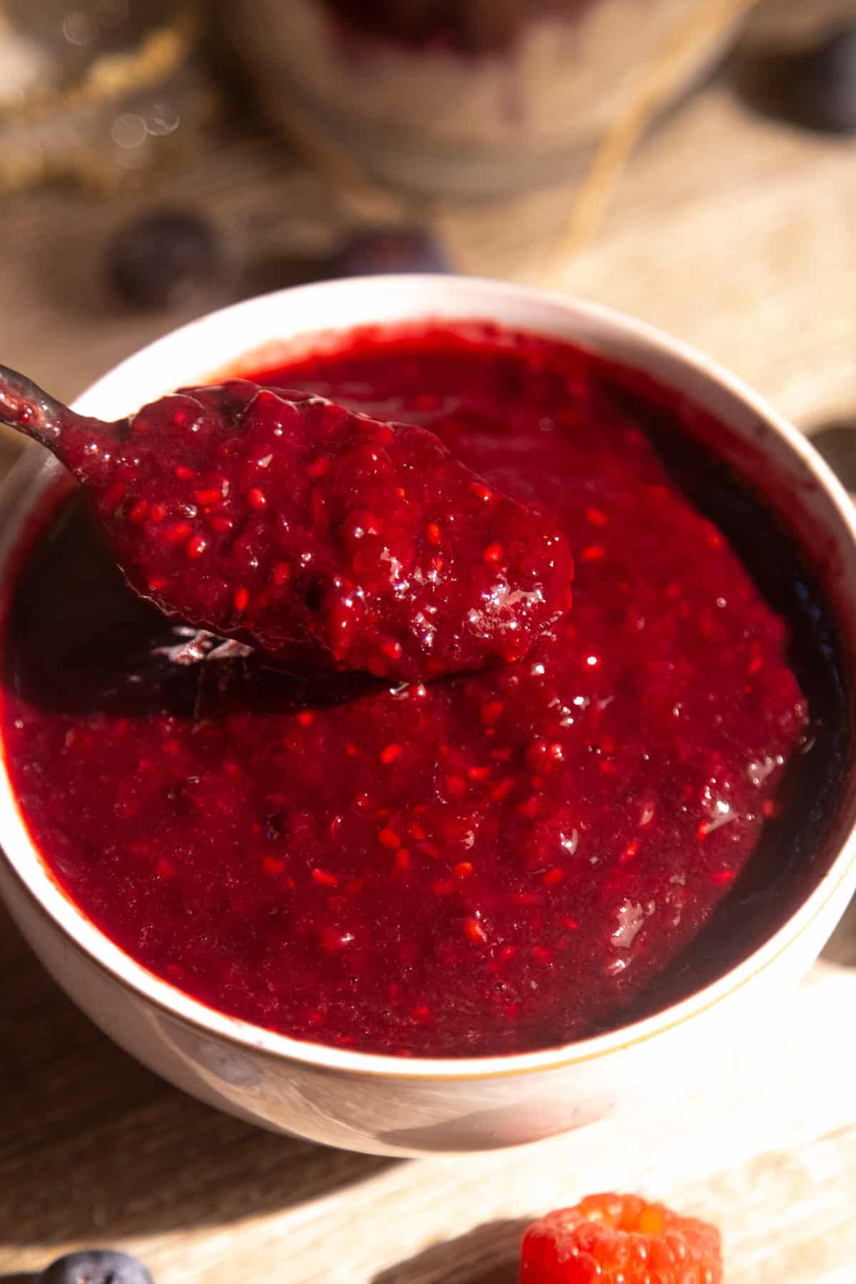 Easy berry sauce recipe in a white bowl.