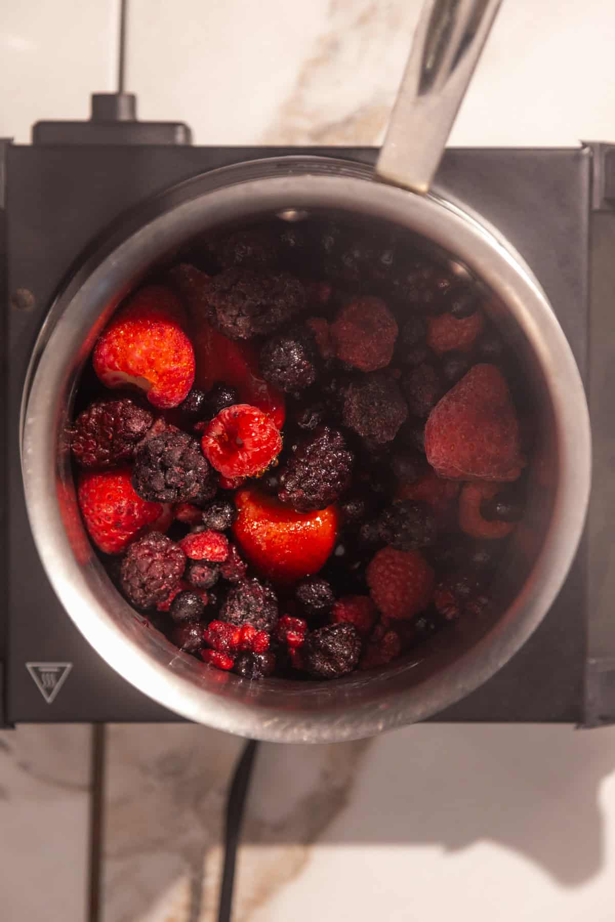 Frozen berries in a saucepan.