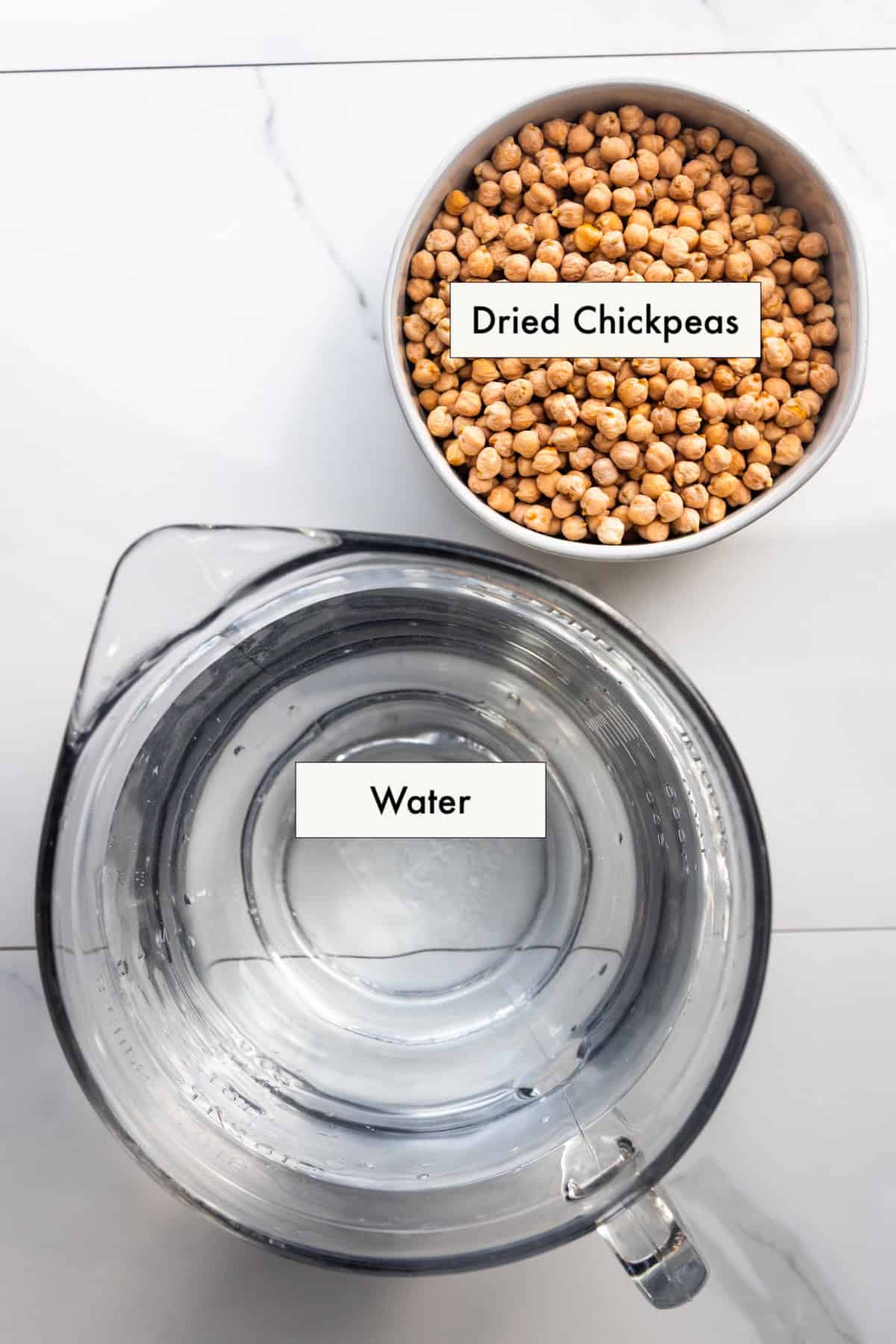 All ingredients for instant pot chickpeas in labeled bowls on a counter.