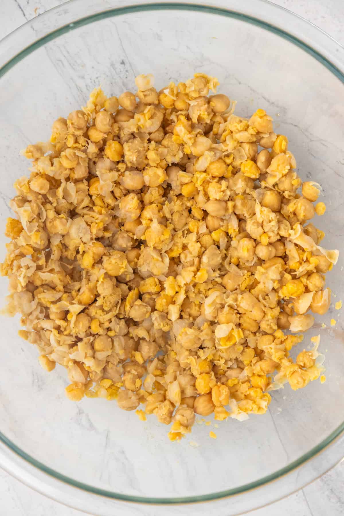 Mashed chickpeas in a bowl.