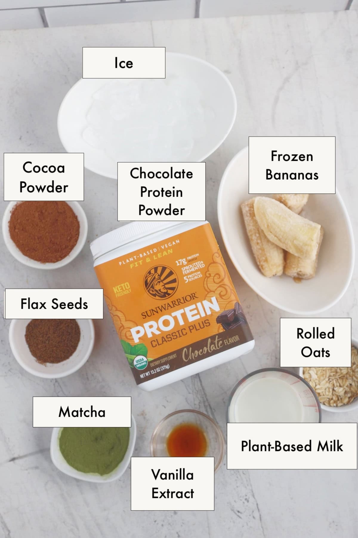 All ingredients for chocolate matcha smoothie laid out on a counter.