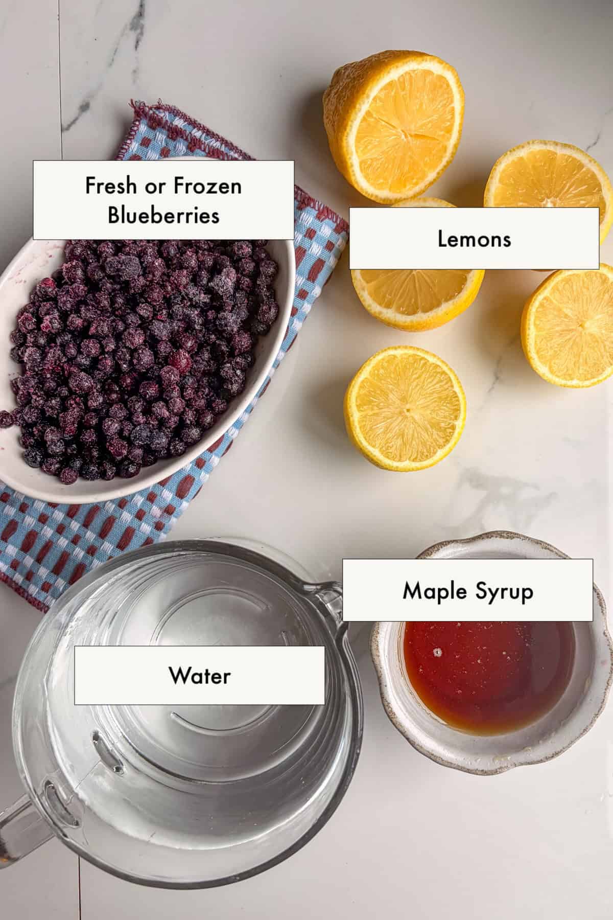 Ingredients for easy blueberry lemonade recipe laid out a counter.
