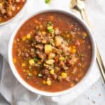 Lentil vegetable soup in a white bowl.