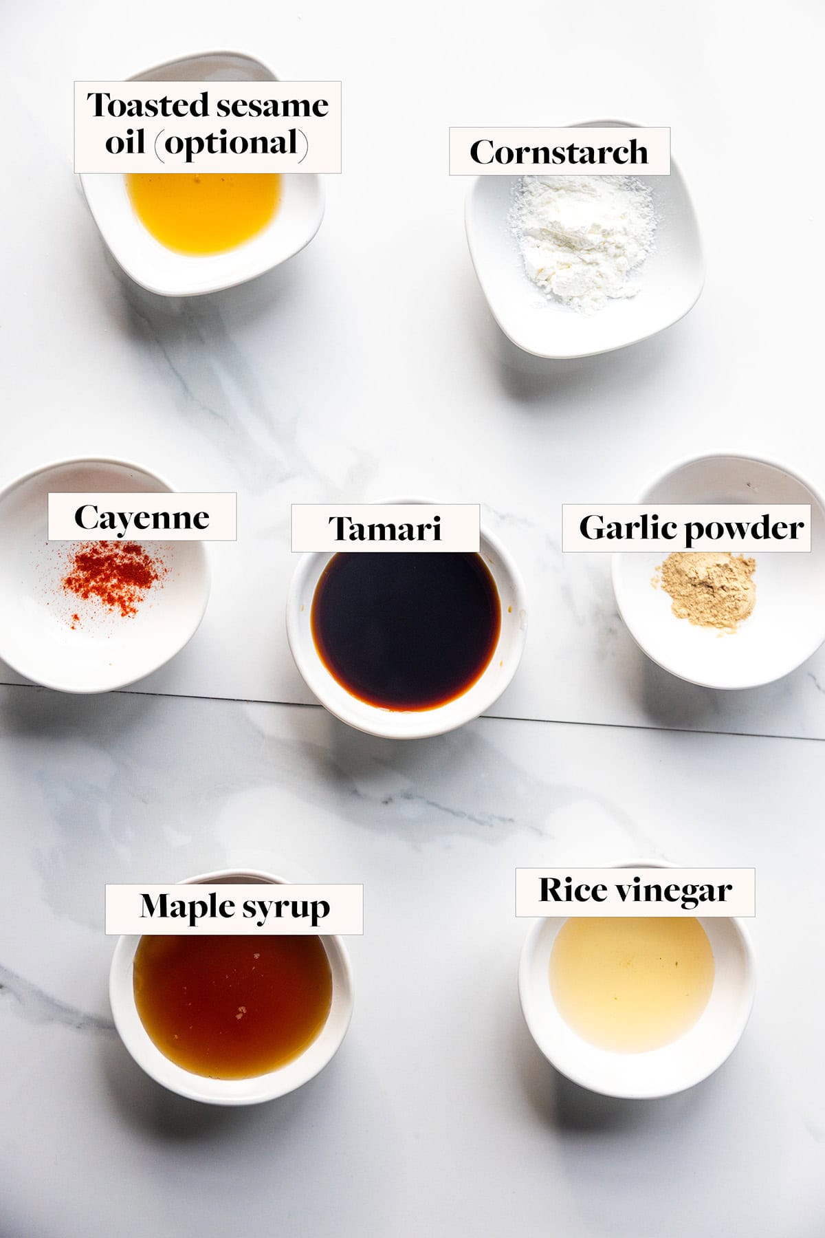 Ingredients for sticky maple glaze sauce in labeled bowls.