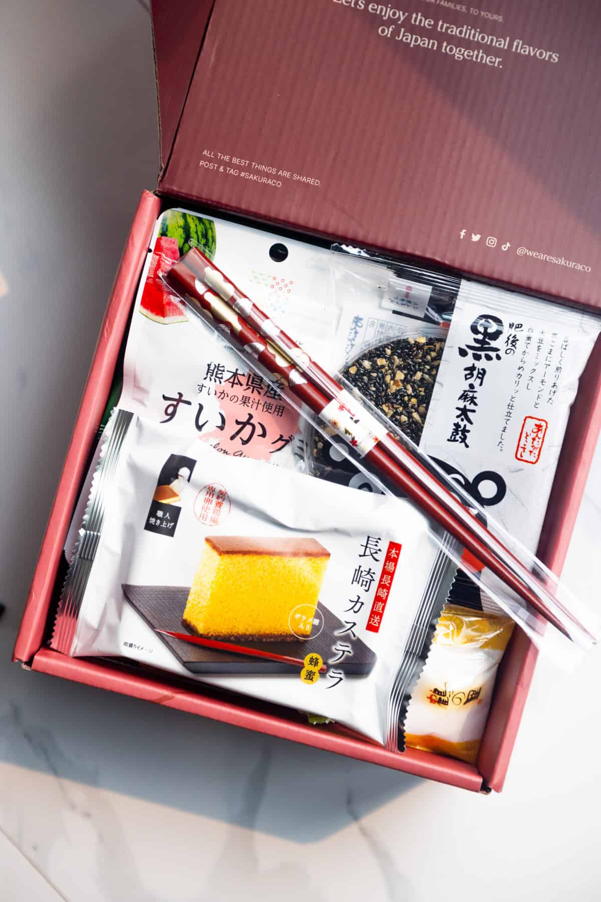 Inside of Sakuraco snack box showing chopsticks and other treats.