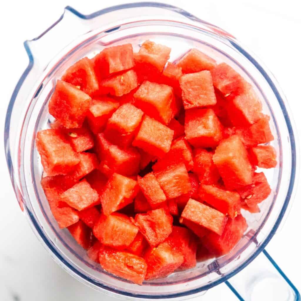 Chopped watermelon in a blender.