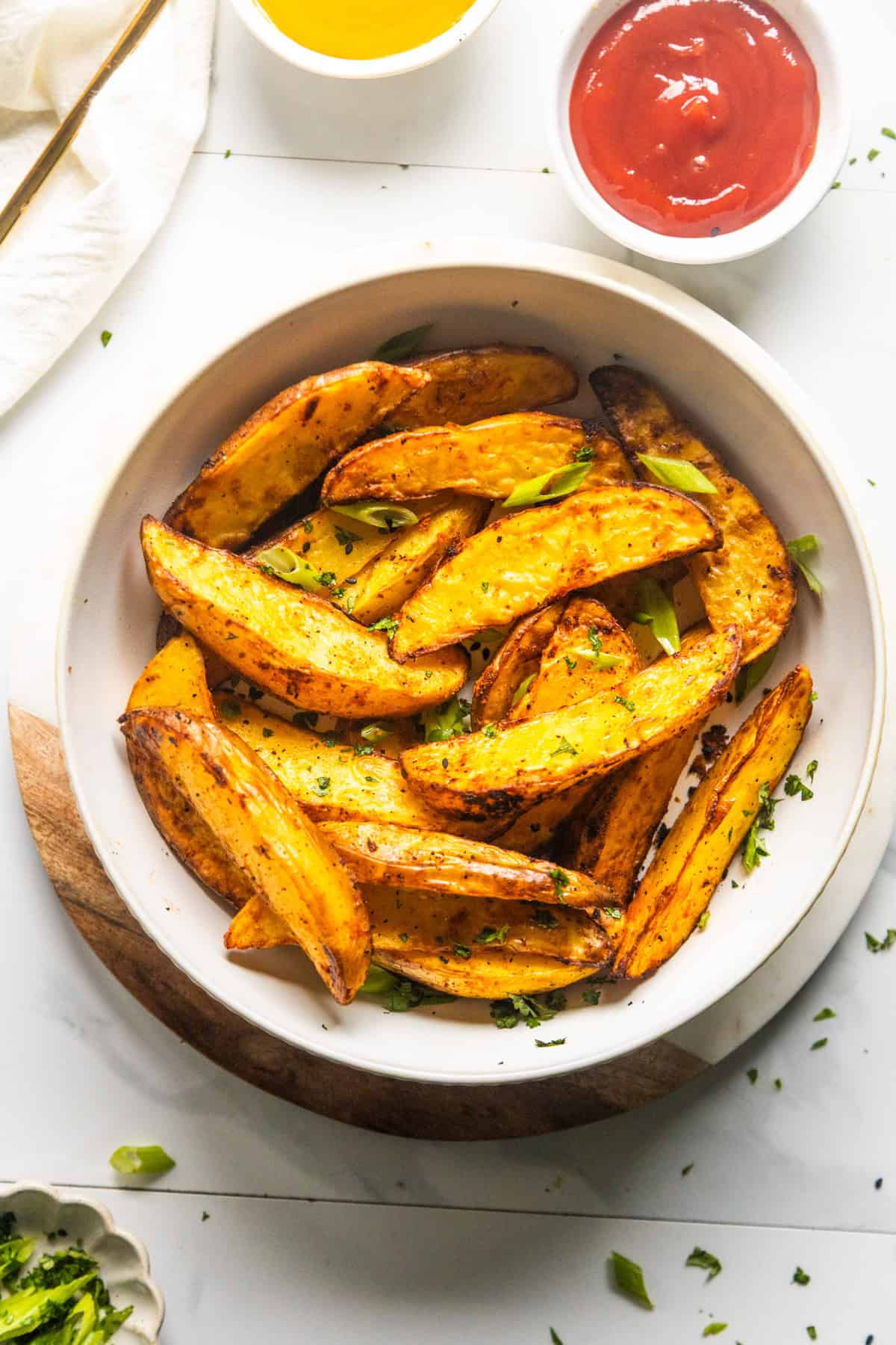Air fryer potato wedges in a bowl.
