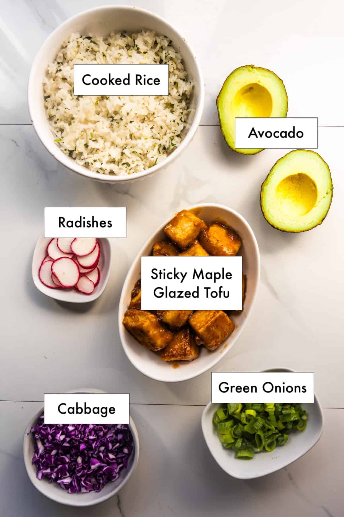 All ingredients needed to make for sticky maple glazed tofu rice bowl, on a counter.