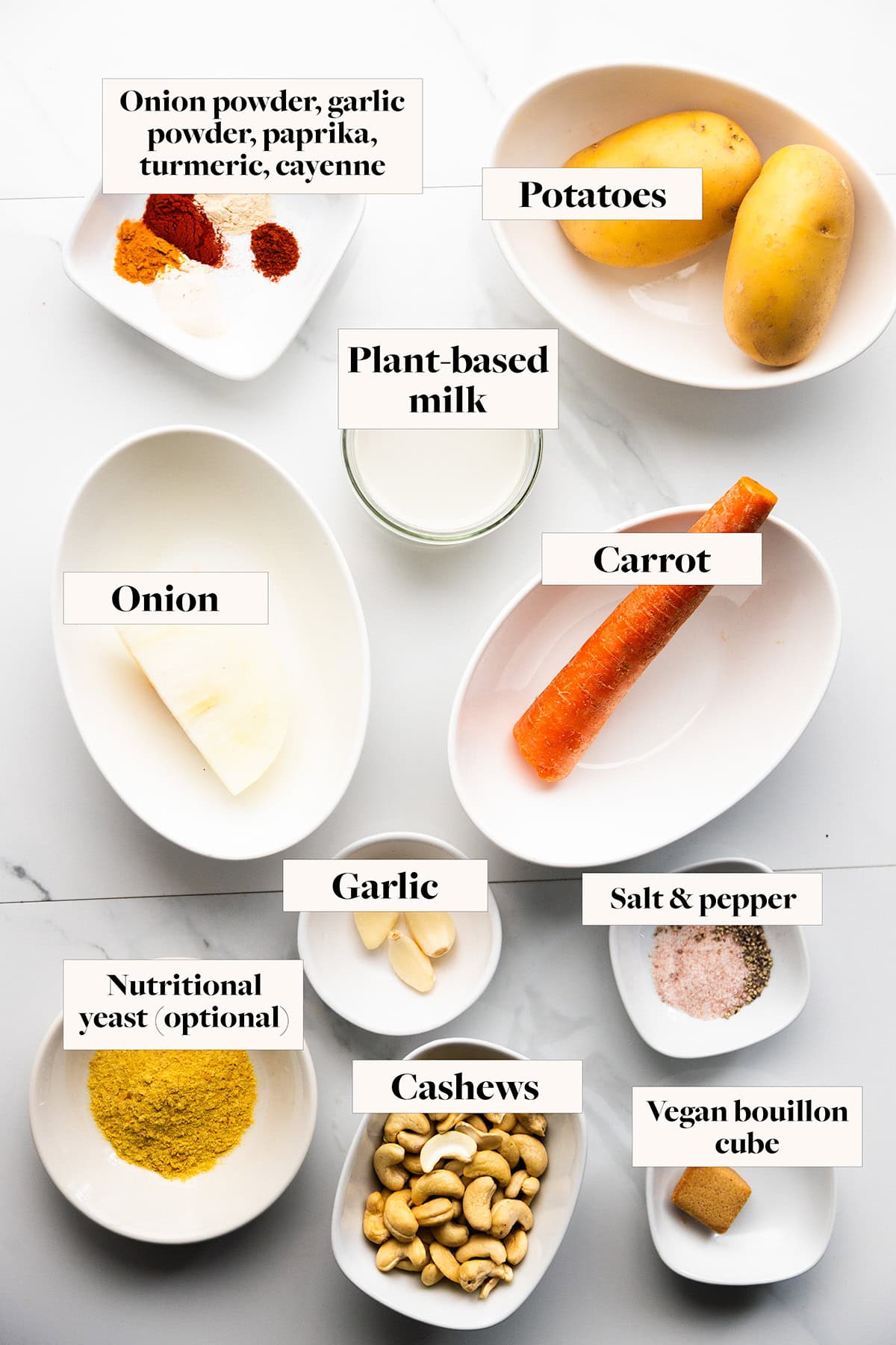 Ingredients for vegan cheese sauce in labeled bowls.