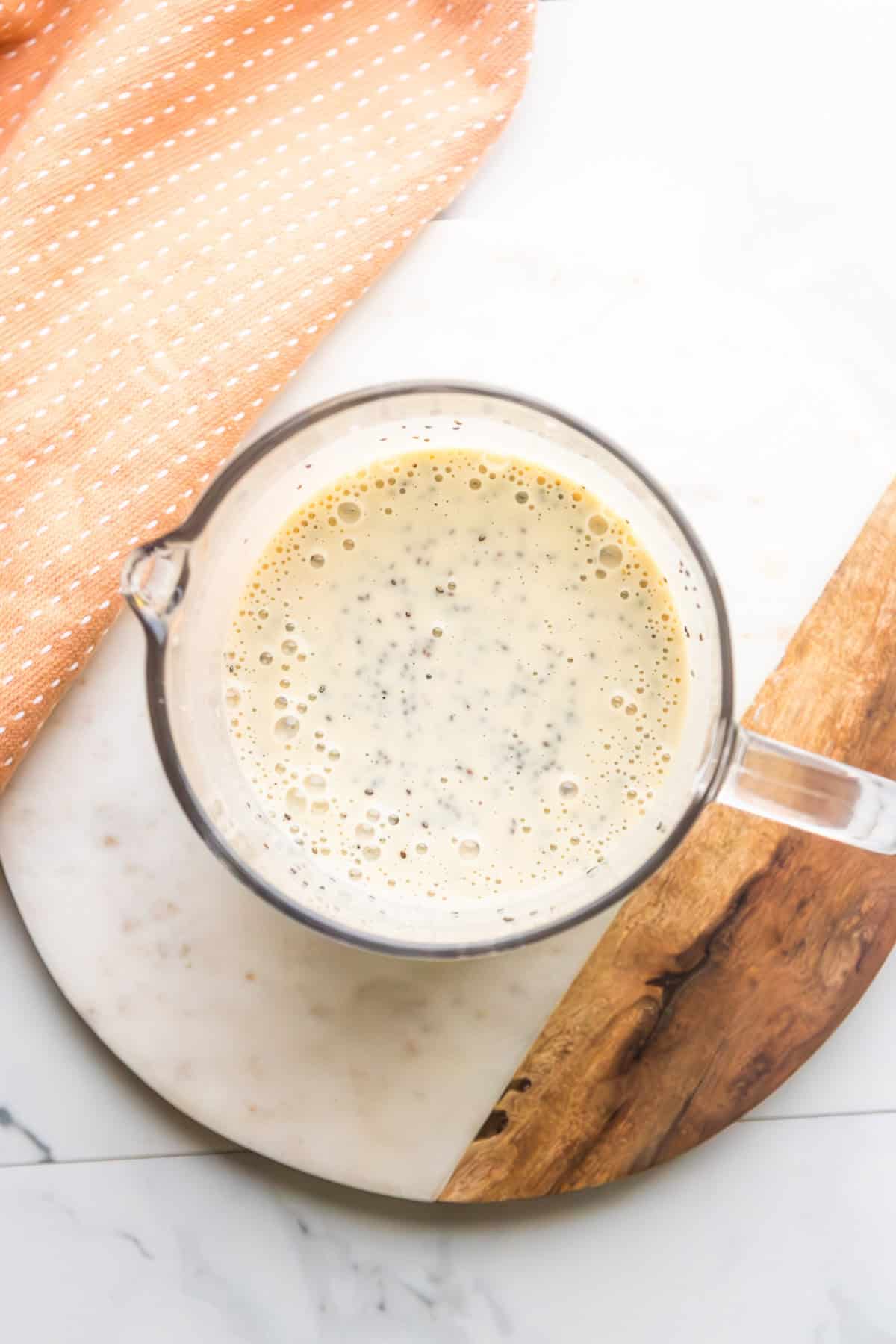 Protein chia pudding being mixed in a bowl.
