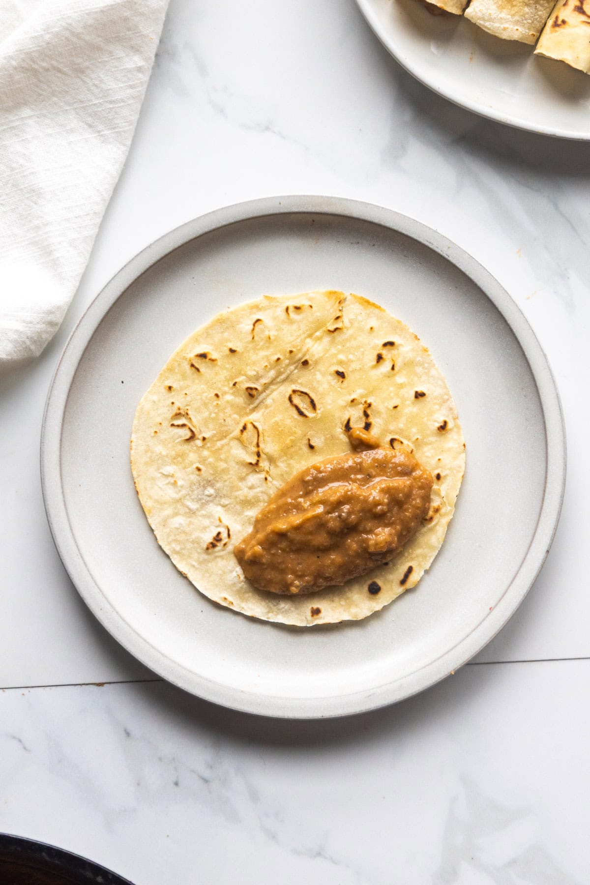 Vegan taquito with bean filling on a plate.