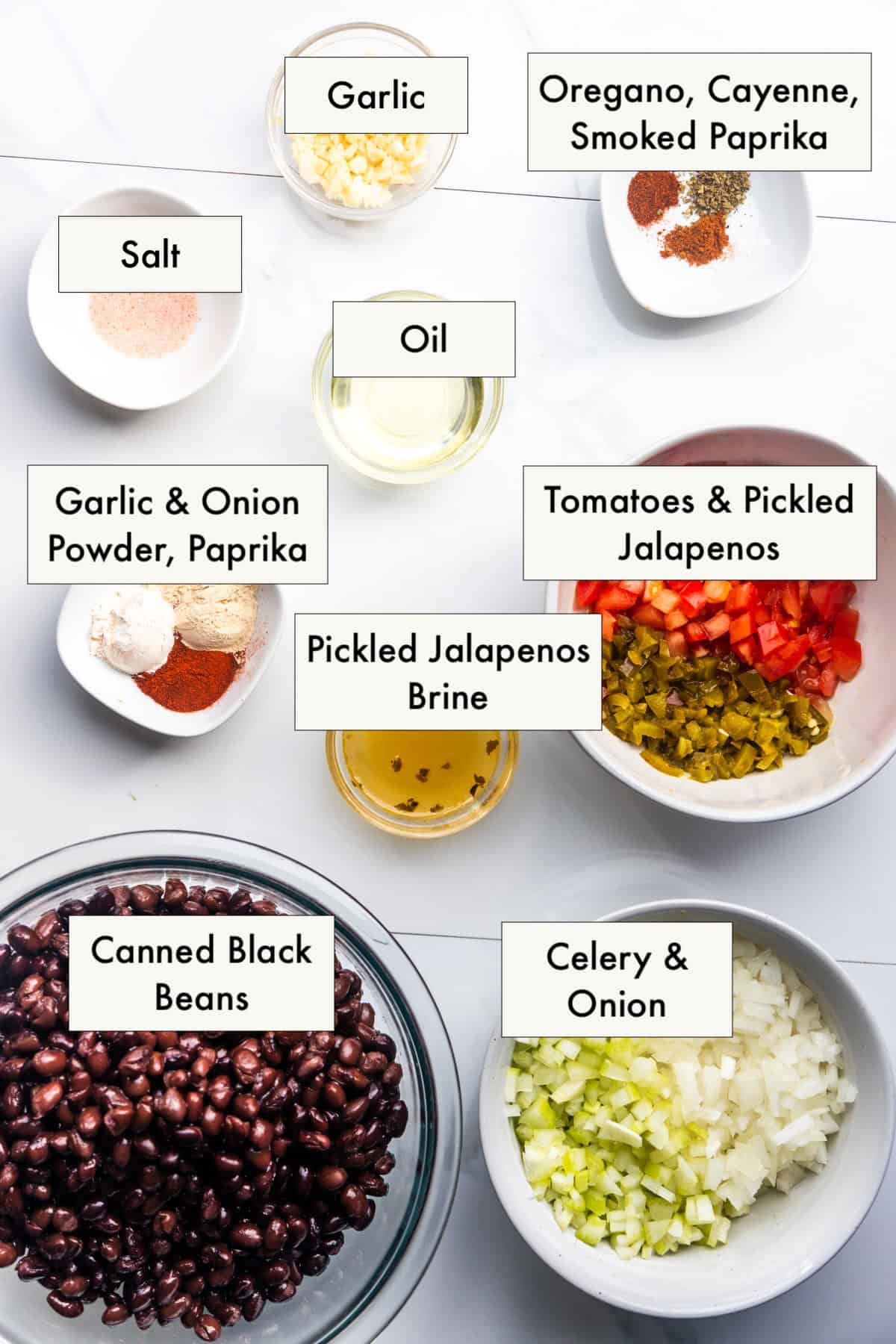 Ingredients for vegan refried black beans from canned beans in labeled bowls.