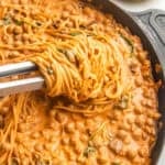 Marry me chickpeas with pasta in a skillet with naan on the side.