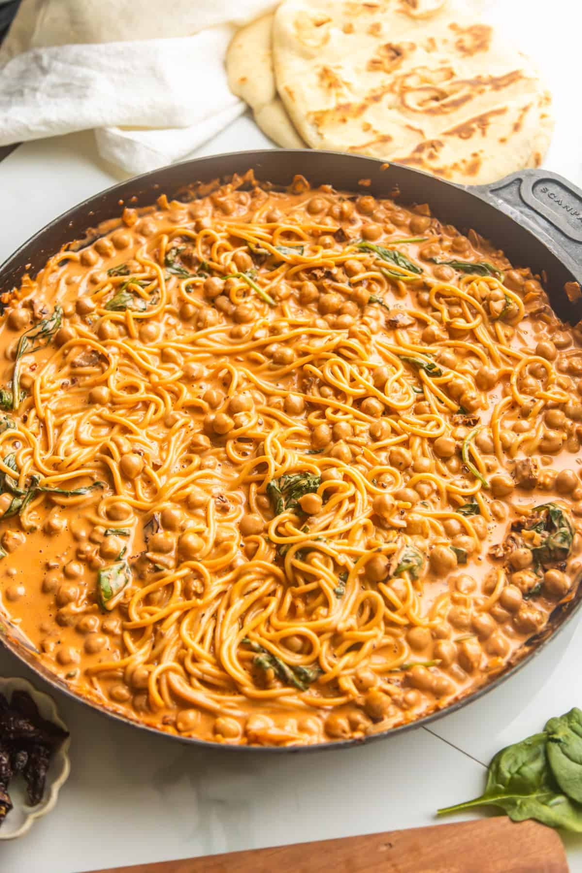 Marry me chickpeas with pasta in a skillet with warmed up naan on the side.
