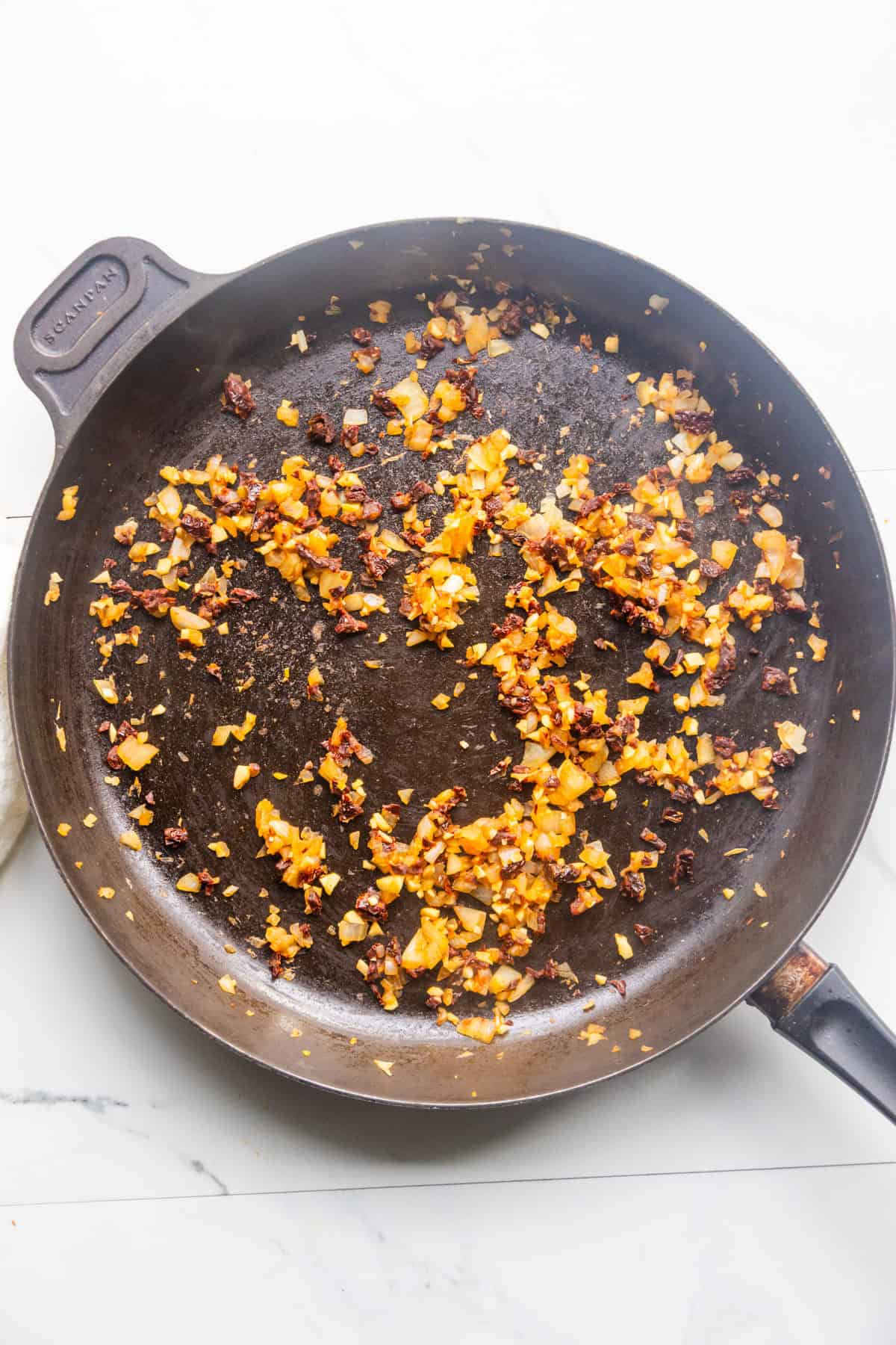 Onions sautéing in a skillet.