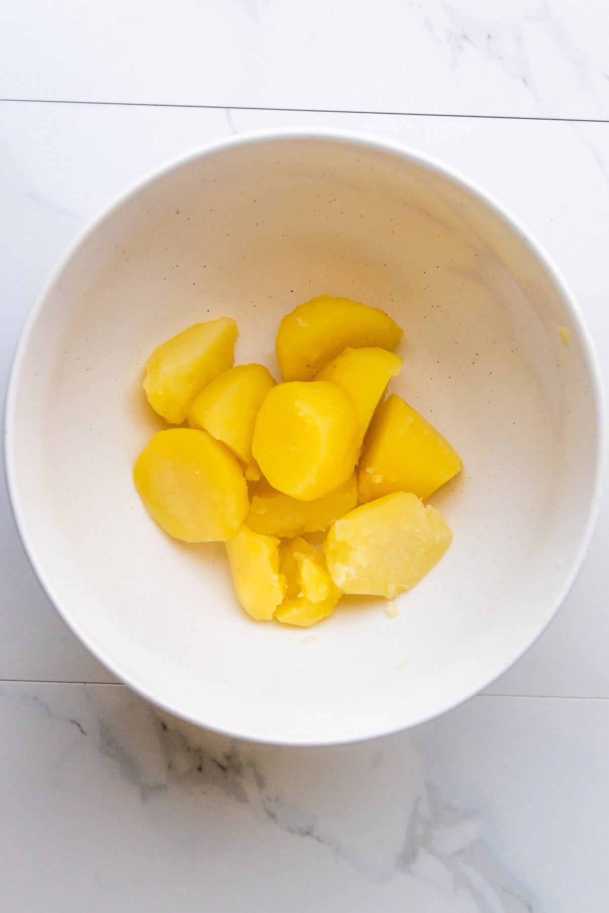 Cooked Yukon Gold potatoes in a bowl.