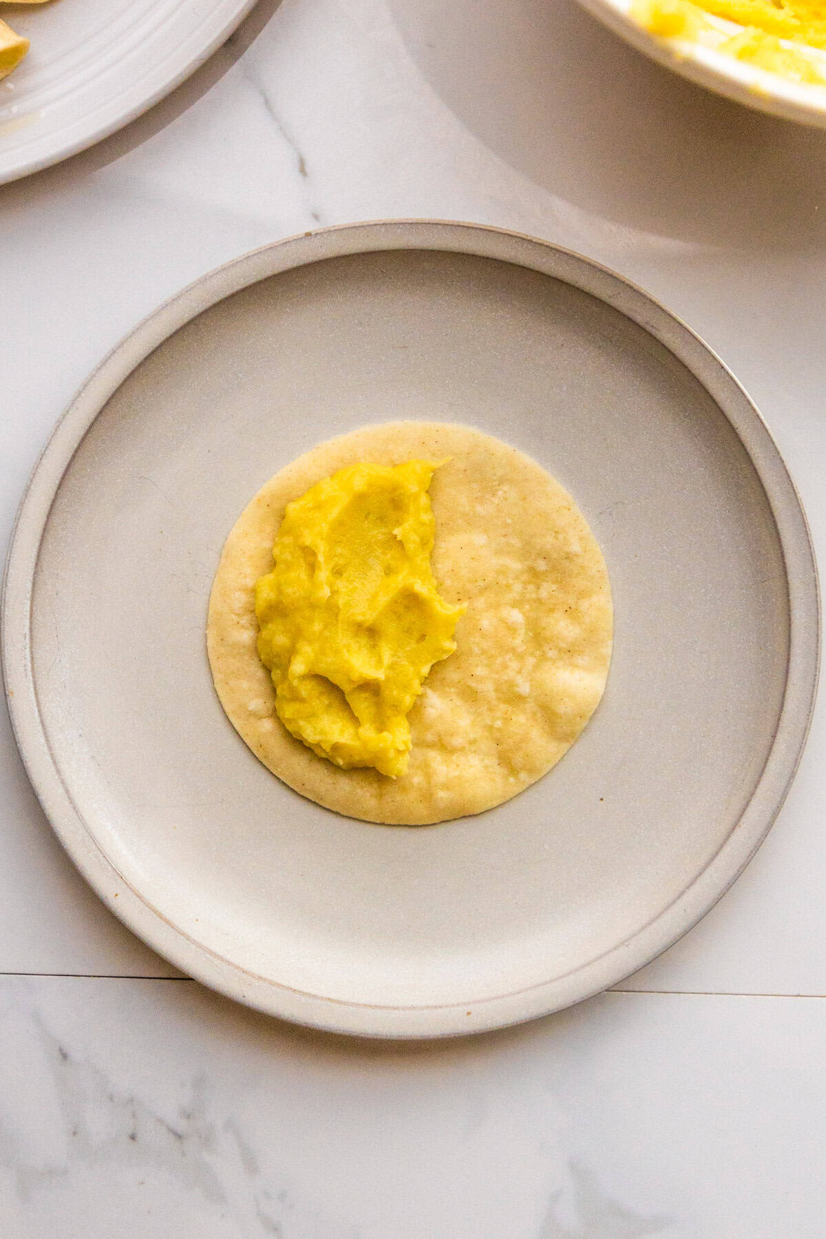The filling for potato tacos spread on a tortilla.