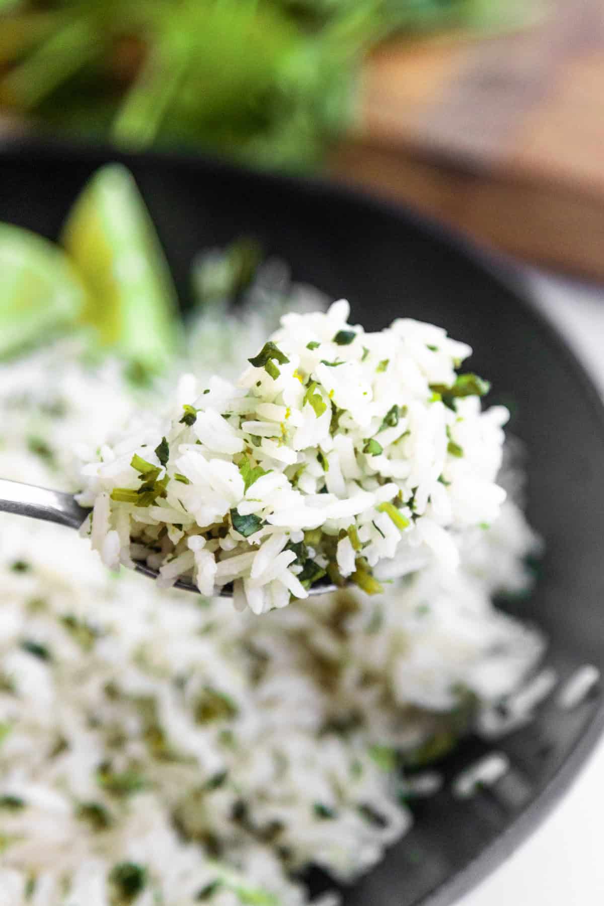 Spoon scooping up rice for burritos (cilantro lime rice)
