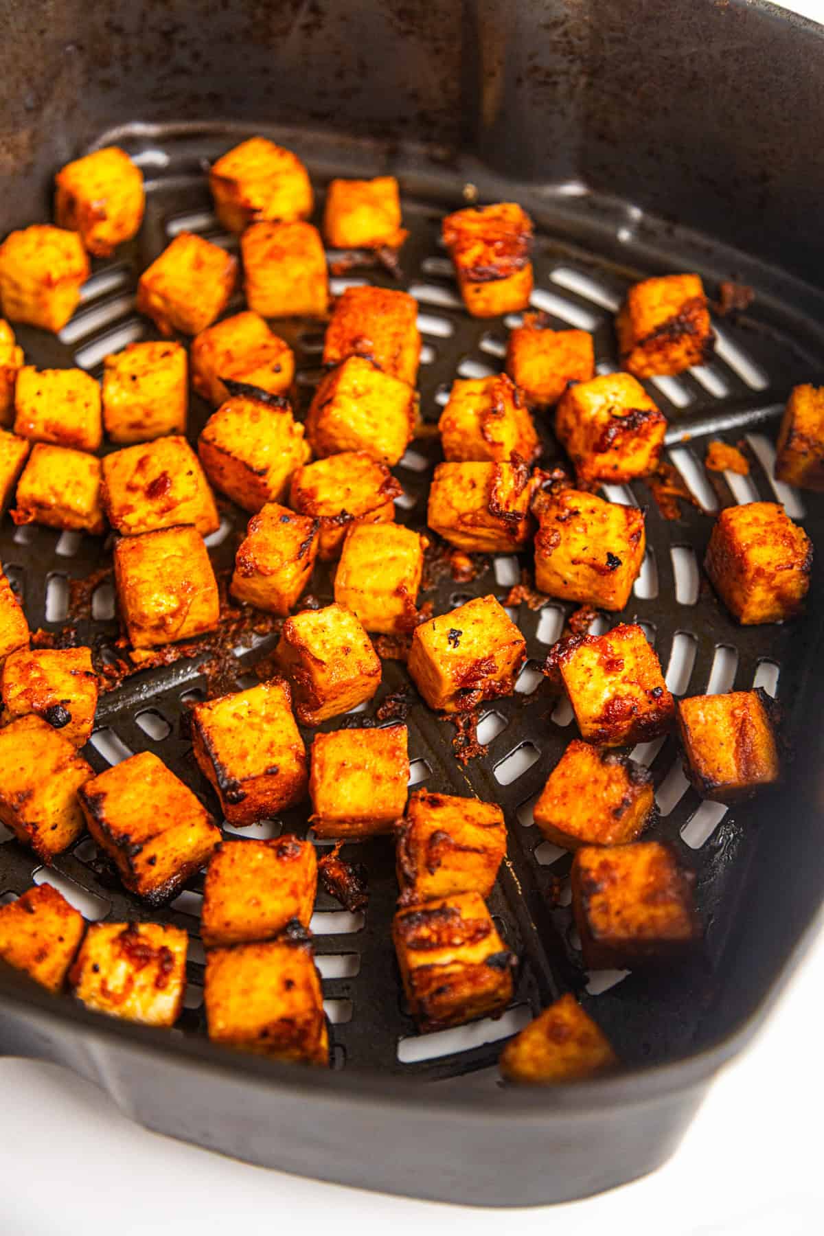 Sweet and spicy maple sriracha tofu after cooking in an air fryer.
