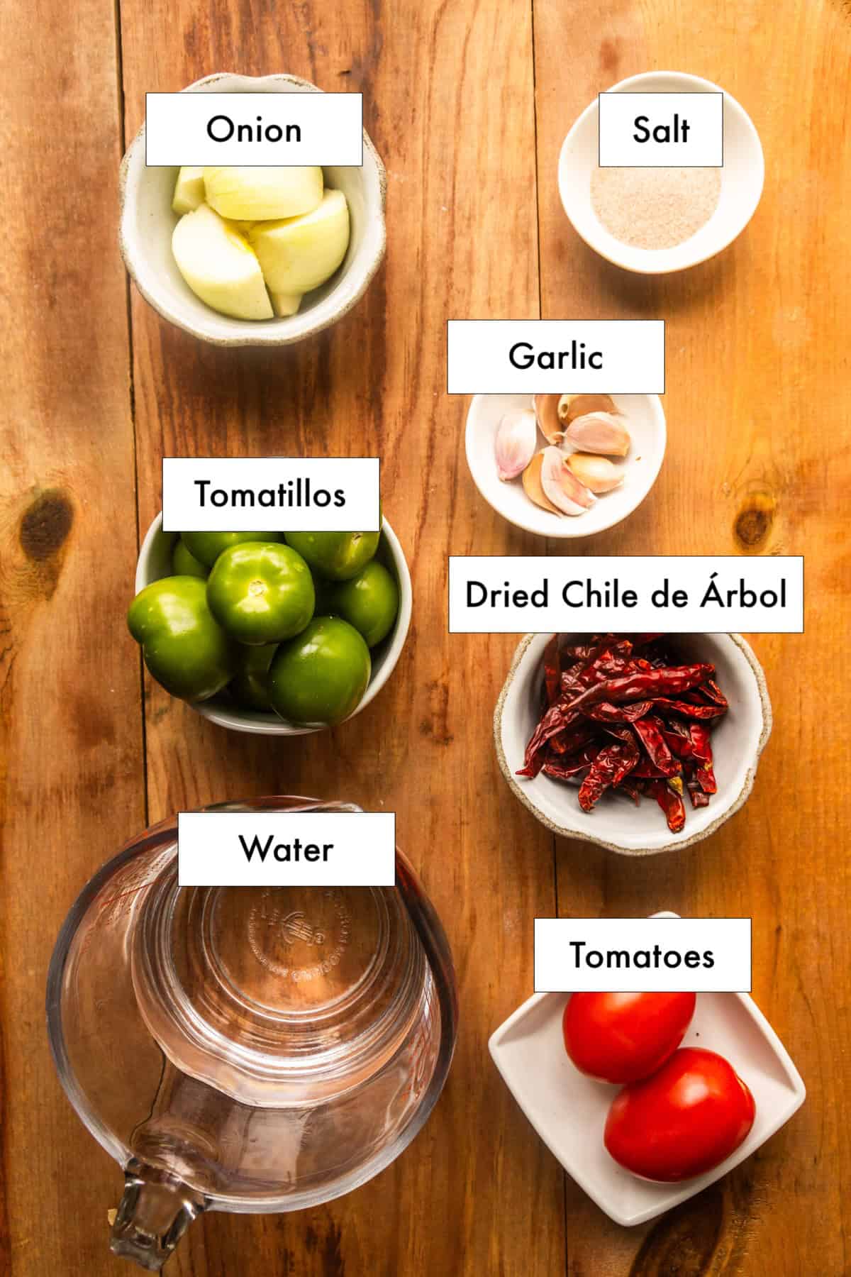 All ingredients for toasted chile de árbol salsa recipe laid out on a counter.