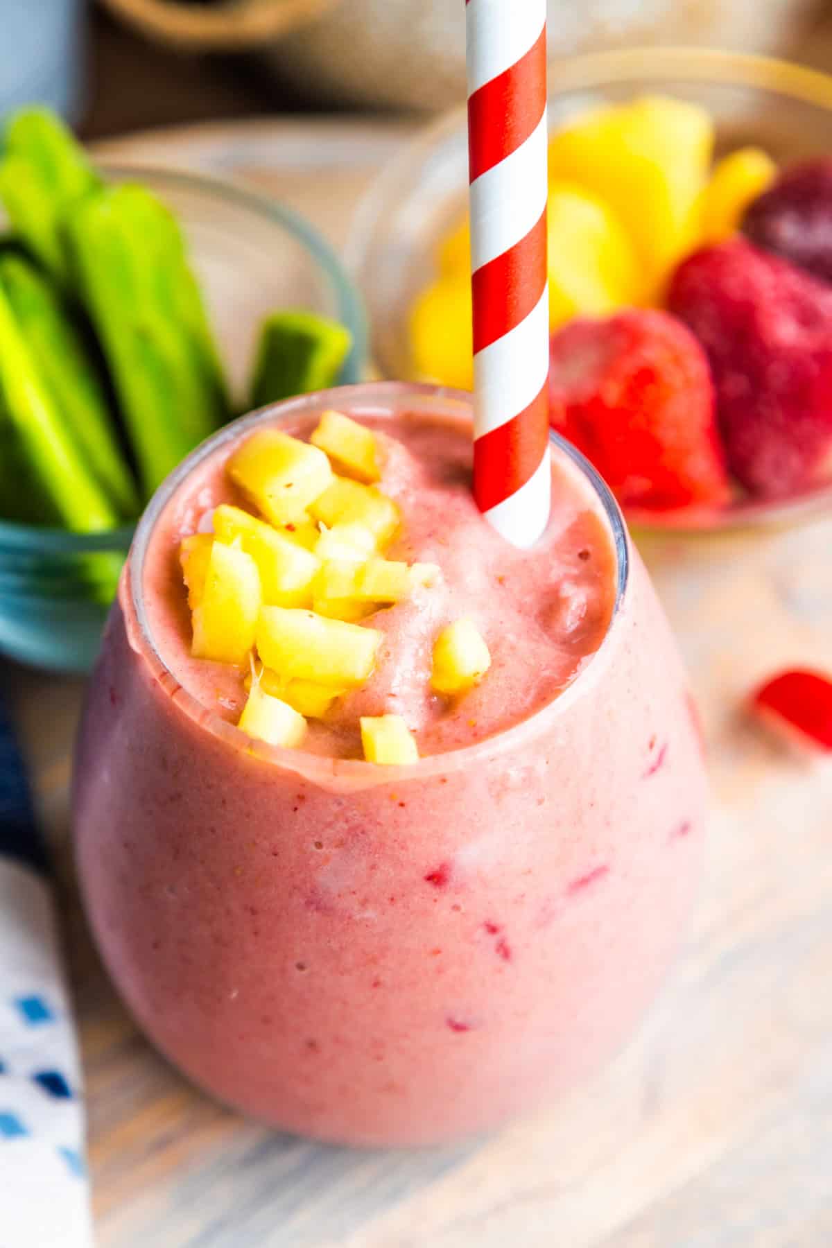 Cactus smoothie (licuado de nopales) in a glass with nopales fresh fruit on the side.
